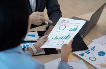 Business team analyzing financial report in modern office, strategy concept