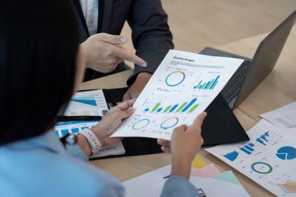 Business team analyzing financial report in modern office, strategy concept