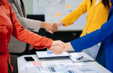 Business partnership handshake concept.Photo two coworkers handshaking process.