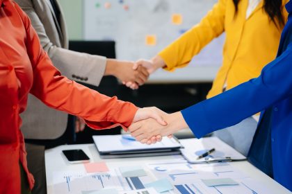 Business partnership handshake concept.Photo two coworkers handshaking process.